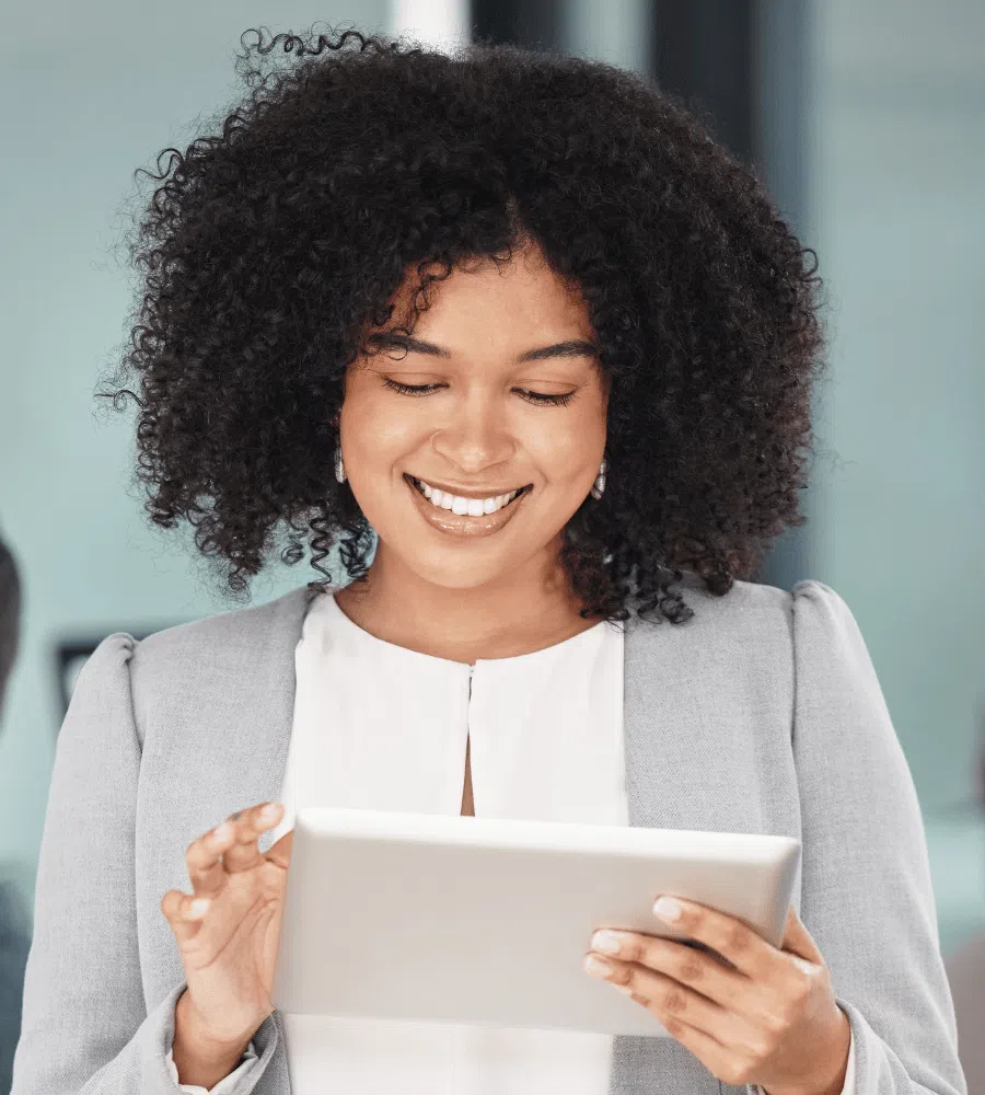 Smiling businesswoman engaging with a tablet, reflecting customer relationship management and business automation themes for SharpShell Digital.
