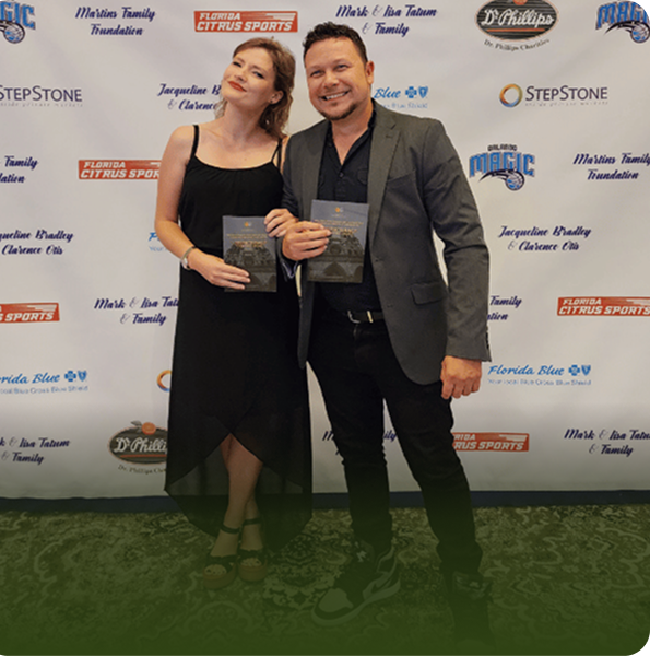 Raul Nazario and Joanna Nazario Grzechowiak holding programs at the William Daniel Mills Theatre Company's production of The Hunchback of Notre Dame.