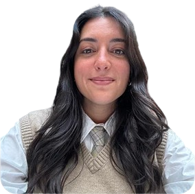 Professional woman with long dark hair wearing a beige vest and white shirt, representing SharpShell Digital's diverse team of digital marketing experts.